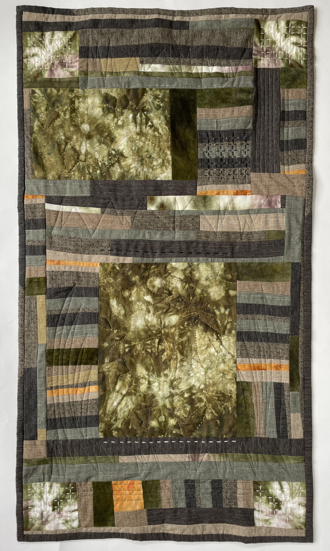 collagelike quilt with abstract pieces and leaflike shapes