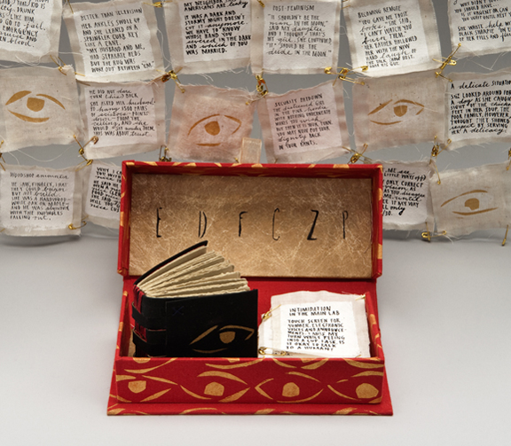 handmade box with poems handwritten on patches and book
