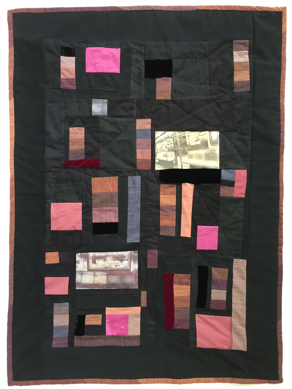 pieced quilt with colored patched surrounded by black and two photos of empty New York City subway cars